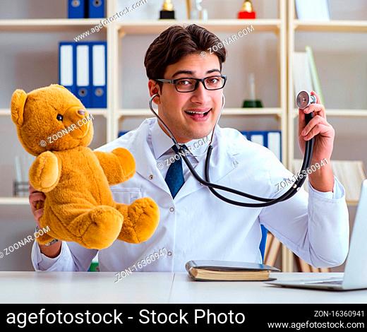 Doctor veterinary pediatrician holding an examination in the office with a teddy bear