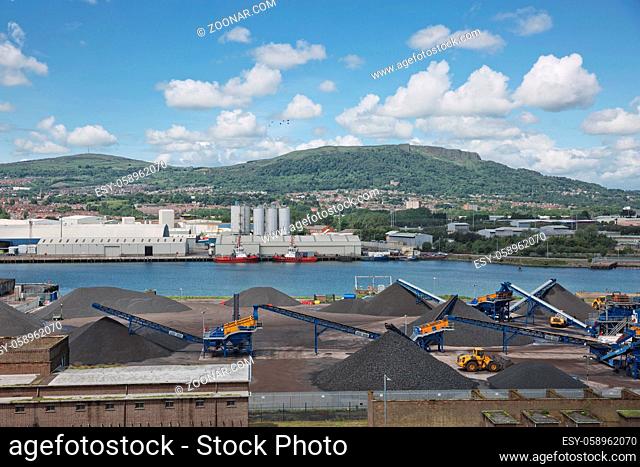 Belfast, Northern Ireland - June 9, 2017: A view across Belfasts dockland from HMS Caroline in the Titanic Quarter with Carrs glen and Napoleon's Nose in the...