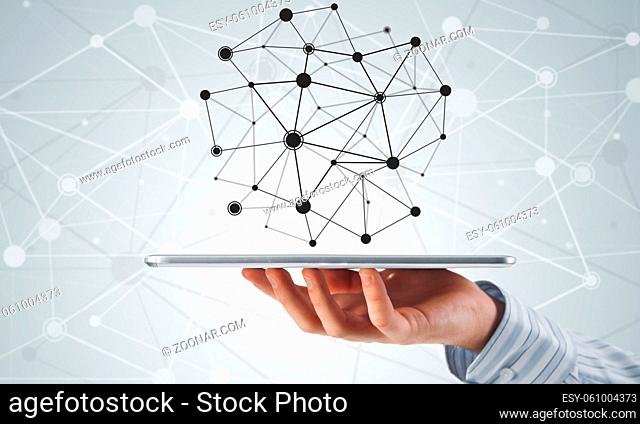 Hand of businessman showing tablet pc as concept of global connectivity