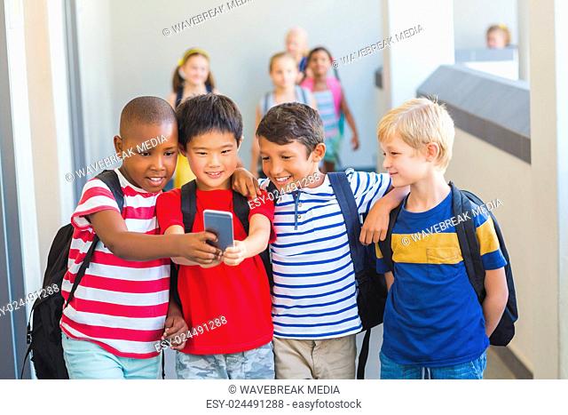 School kids taking selfie on mobile phone