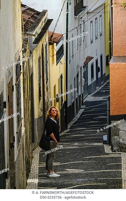 Paul Do Mar, Madeira, Portugal A woman tourist walking along an old street