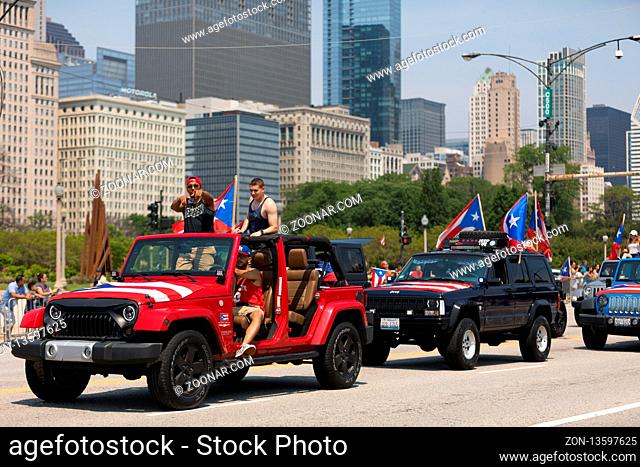Chicago, Illinois, USA - June 16, 2018: The Puerto Rican Day Parade, Puerto Ricans driving Jeeps with puerto rican flags on them during the Puerto Rican Day...
