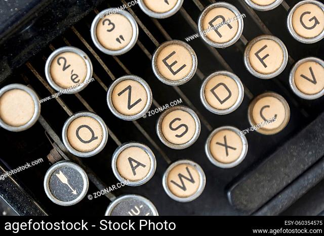close-up view from above of the dusty keys of an old typewriter. Old mechanical tool for writing. Journalism and storytelling