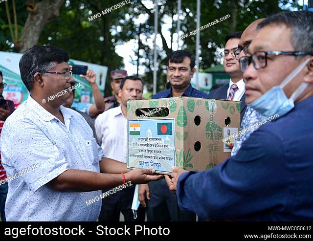 Officials of the India High Commission hand over the first packet of Pineapples to Bangladesh officials, sent by Tripura Chief Minister Manik Saha
