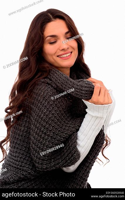 Beautiful female brunette looking down. Wearing fashion gray cardigan. Mid age woman over 35 years old beauty concept