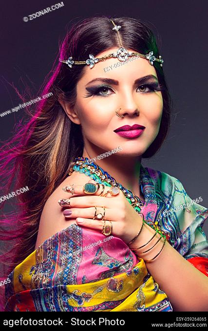 Beautiful young woman with eastern style bright makeup. Beauty shot