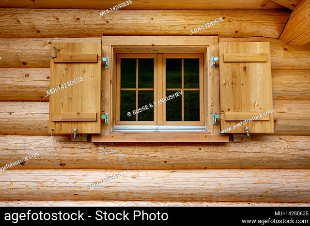 Windows in a log house from thick wooden beams