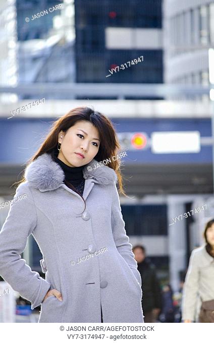 Japanese Girl poses on the street in Ginza, Japan. Ginza is a shopping city located in Tokyo