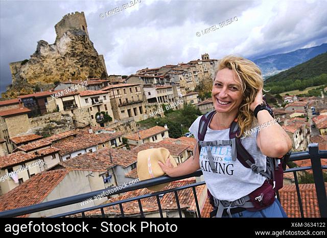 Young mature tourist woman with a hat in a viewpoint. Frias town. Burgos province. Castile and Leon, Spain