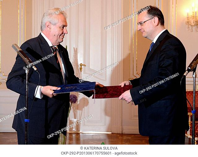 Czech Prime Minister Petr Necas (Civic Democratic Party, ODS), right, tenders his resignation to President Milos Zeman, left