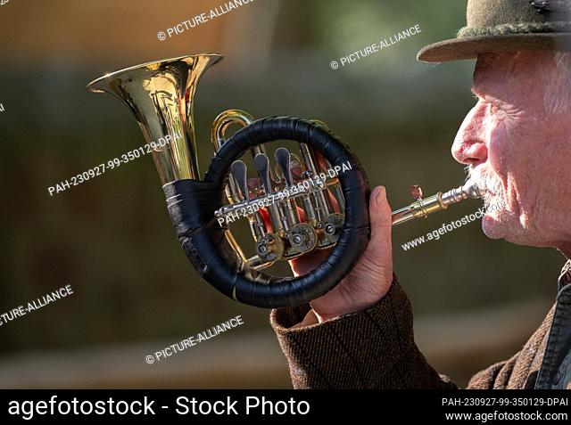 26 September 2023, Saxony, Moritzburg: A hunting horn blower plays at the opening of the new entrance building at the Moritzburg Game Reserve