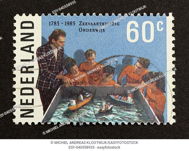 HOLLAND - CIRCA 1980: Stamp printed in the Netherlands shows the education of five children, circa 1980