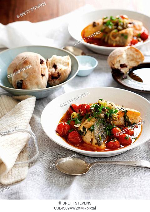 Sicilian monkfish stew and bread rolls