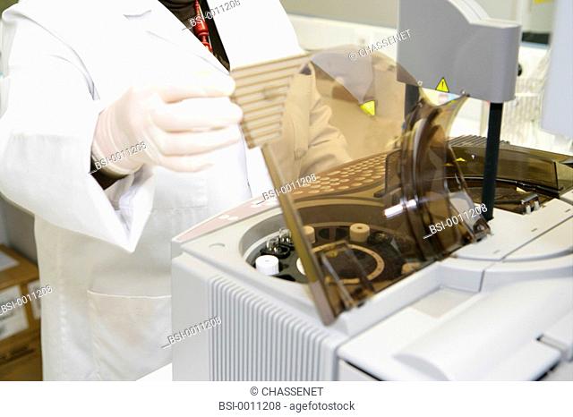 Photo essay from laboratory. Automaton of hemostasis Diagnostica Stago. Analysis of blood coagulation. The technician is loading the reactive agents