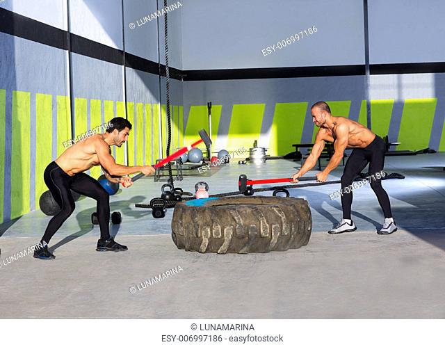 Crossfit sledge hammer men workout at gym