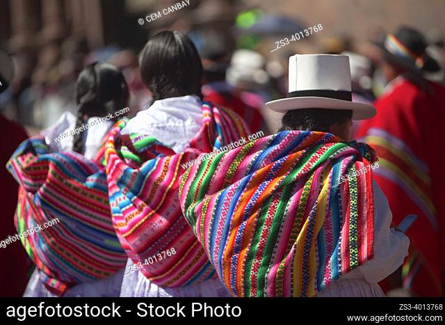 Indigenous people wearing traditional costumes and carrying bowler hat and saddlebags during a performance at the Inti Raymi Festival in Plaza De Armas at the...
