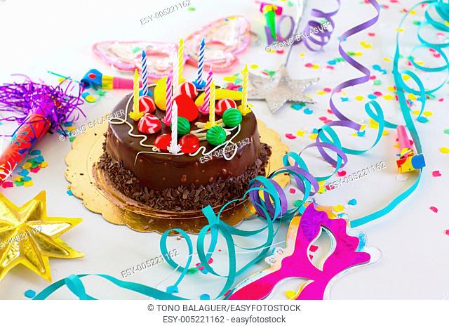Children birthday party with chocolate cake confetti garland and serpentine