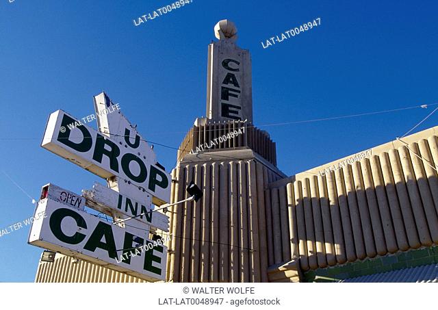U Drop Inn cafe. Looking up at sign. Building behind. Blue sky. Route 66
