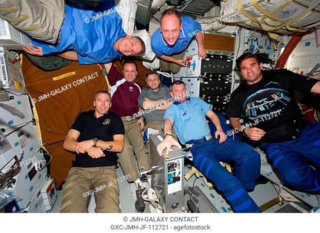 STS-134 and Expedition 28 crew members gather on the middeck of space shuttle Endeavour while docked with the International Space Station