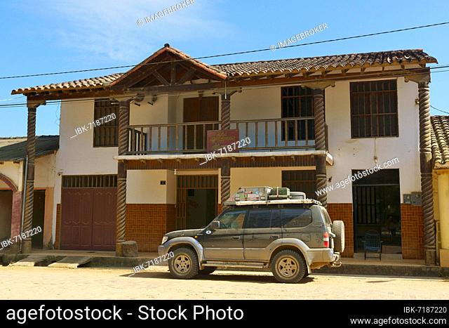 Dusty off-road vehicle, Land Cruiser in front of a hotel in a colonial house, San Ignacio de Moxos, Department of Beni, Bolivia, South America