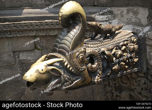 Metal guilded spout in the form of goat being eaten by a makara at Naga Pokhari (Royal Bath) in Bhaktapur, Kathmandu valley, Nepal