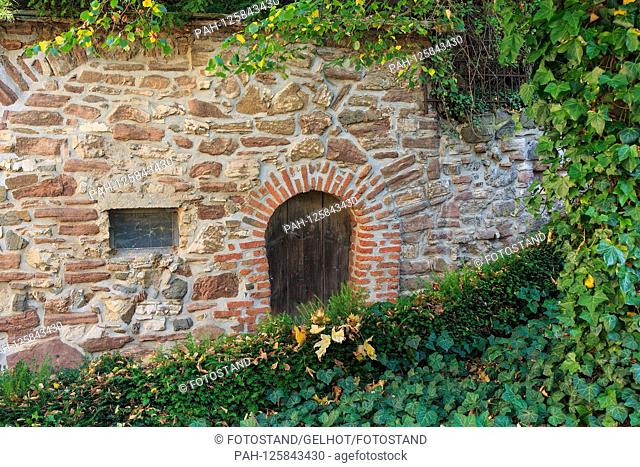 Wernigerode, Germany 14/15 October 2019: Schloss Wernigerode - October 2019 old stone wall with door and Fesnter, foliage, autumn mood
