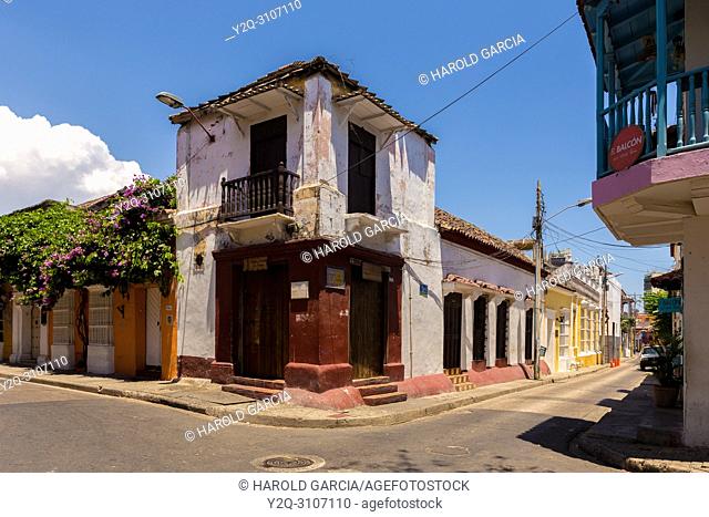 Beautiful houses with large doors, big windows and green foliage n the ancient walled city of Cartagena de Indias. Historical patrimony of the humanity for the...
