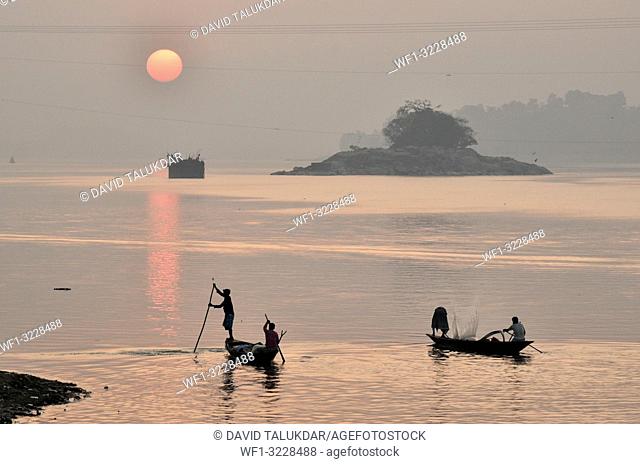 Guwahati, Assam, India. January 30, 2019. Fishermen lays their fishing net at the Brahmaputra River during sunset