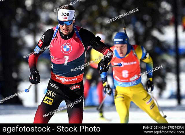 14 February 2021, Slovenia, Pokljuka: Biathlon: World Championship, Pursuit 12.5 km, Men. Sturla Holm Laegreid from Norway ahead of Sebastian Samuelsson from...