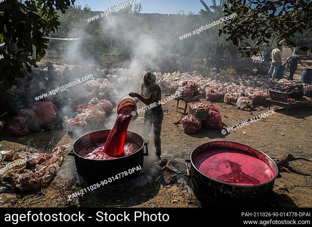 24 October 2021, Syria, Al-Alani: Syrian workers make pomegranate molasses in the Al-Alani village on the Syrian-Turkish border near Idlib province