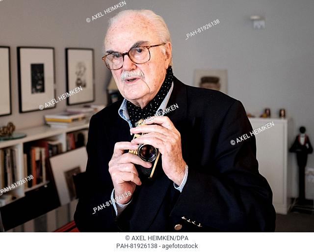 Photographer F.C. Gundlach holds his gold-plated Leica camera in his hands in his flat in Hamburg, Germany, 1 July 2016. Photo: Axel heimken/dpa | usage...