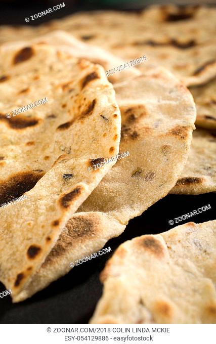 Close up shot of indian chapatis, or roti, traditional unleavened bread to eat with curry. Shallow DOF