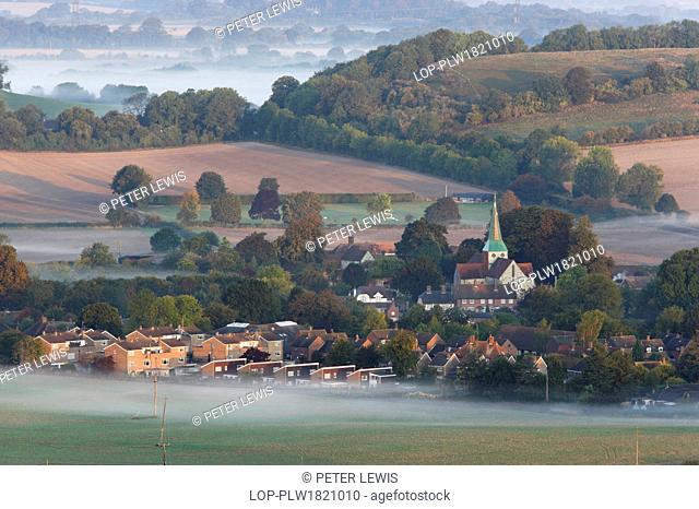 England, West Sussex, South Harting. Dawn mist surrounding the Village of South Harting on the South Downs
