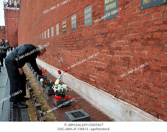 At the Kremlin Wall in Moscow, Expedition 3940 Flight Engineer Steve Swanson of NASA lays flowers in a tribute to Russian space icons who are interred there as...