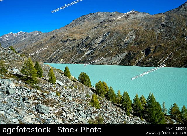 Autumn atmosphere at the Mattmark reservoir with its emerald green water, Saas-Almagell, Valais, Switzerland