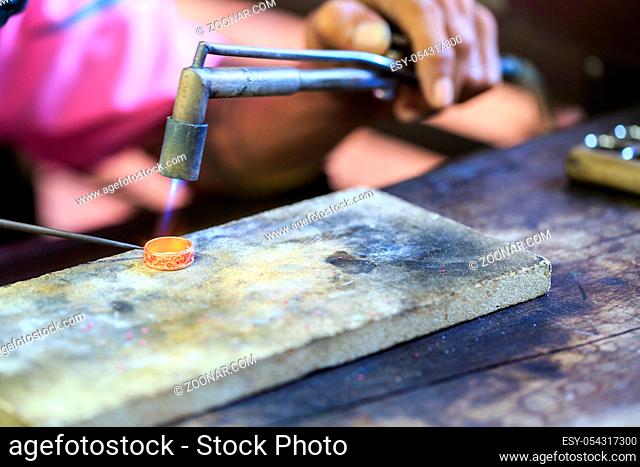 Goldsmith working with a thai traditional ring