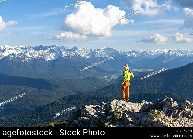 Hiker at the summit of Heimgarten, view into the distance, Karwendel Mountains in the background, ridge walk Herzogstand Heimgarten, Upper Bavaria, Bavaria