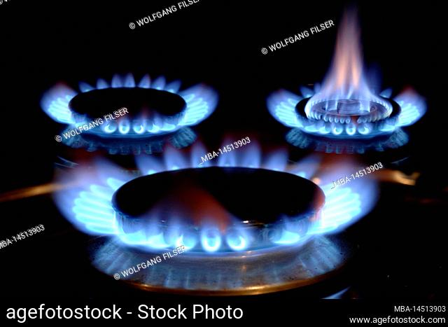 Gas flames burning on a stove with blue flame