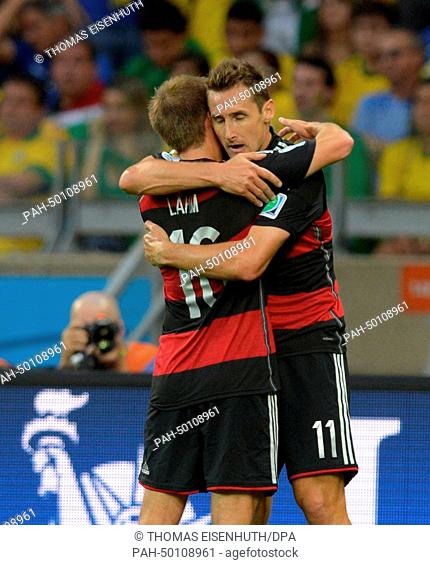 Germany's Miroslav Klose (R) hugs Philipp Lahm during the FIFA World Cup 2014 semi-final soccer match between Brazil and Germany at Estadio Mineirao in Belo...