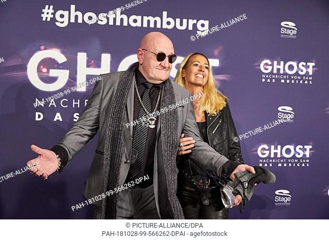 28 October 2018, Hamburg: Eddy Kante, former bodyguard of Udo Lindenberg and his companion Petra Delia Brennemann arriving to the Hamburg premiere of the...