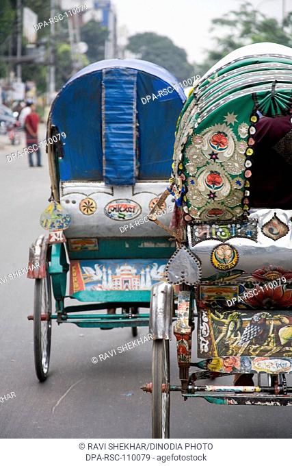 Two Cycle Rickshaw moving on street of Dhaka ; Bangladesh