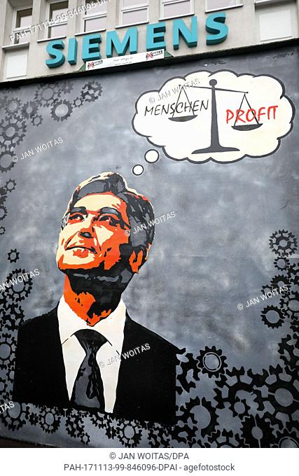 A protest siugn with the picture of Siemens head Joe Kaeser pictured in front of Siemens' turbo engines factory in Leipzig, Germany, 13 November 2017