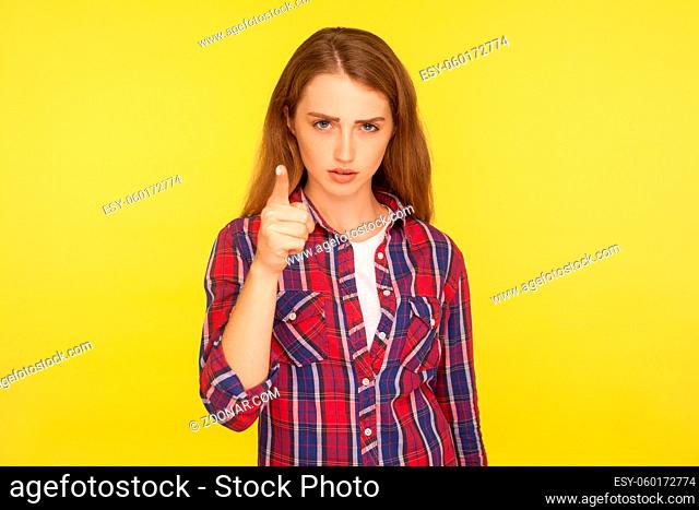 I told you. Portrait of angry ginger girl in checkered shirt looking at camera and blaming warning you with raised finger, showing admonishing gesture