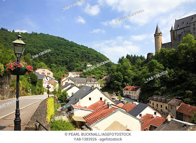 Vianden, Grand Duchy of Luxembourg, Europe  Aproach road and rooftops of village houses with hilltop castle beyond