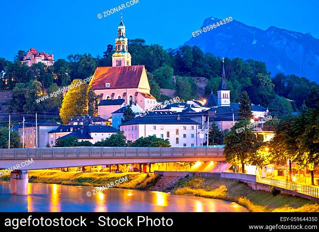 Salzburg historic architecture and mountain peaks background evening view, city in Austria