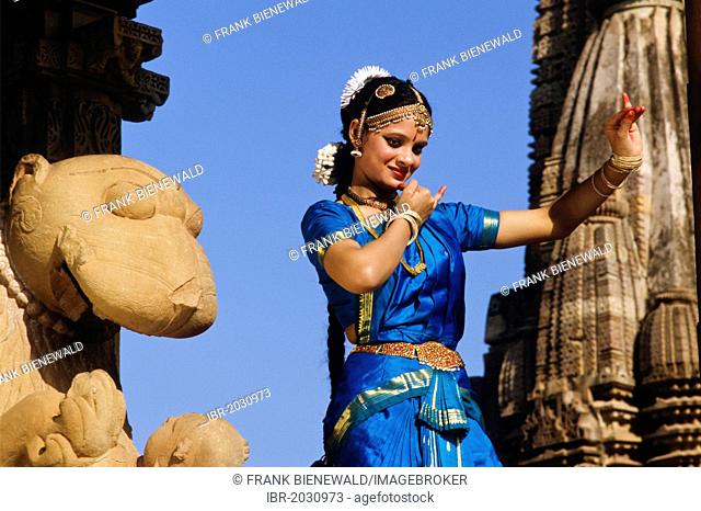 Odissi dancer posing in front of the Khajuraho temples, Khajuraho, Madhya Pradesh, India, Asia