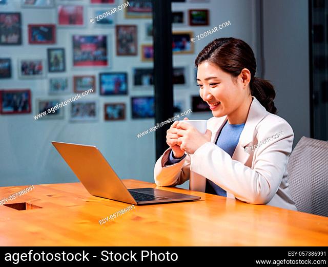Business women use laptops with a cup of coffee