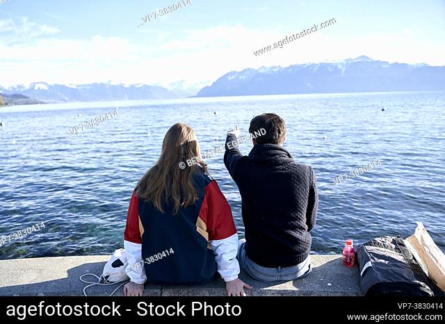 couple looking at mountains Cornettes de Bise, alps, behind lake Geneva, view from Lausanne, Switzerland, Europe