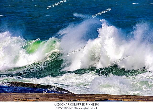 Big, dangerous waves during tropical storm in the green and blue waters of Rio de Janeiro, Brazil