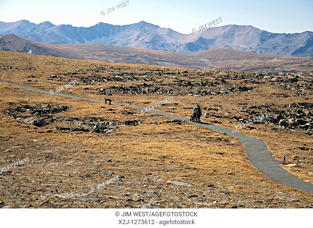 Rocky Mountain National Park, Colorado - A man pushes a woman in a wheelchair on the Tundra Communities Trail, a wheelchair-accessible trail 12